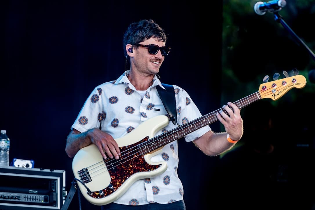Blue Vinyl bassist playing Fender Precision Bass on stage